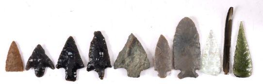 A collection of hardstone and glass arrowheads and shards, one titled 'Narragansett Pier,