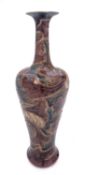 A Royal Doulton stoneware vase of slender baluster form incised with stylised foliage and inscribed