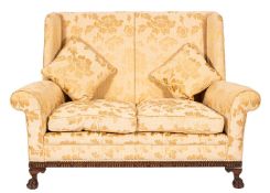 A carved beechwood wing frame twin seat settee, in the Georgian taste,