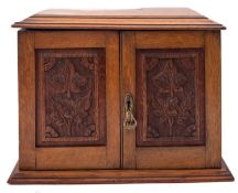 An Edwardian oak and brass mounted smoker's cabinet,