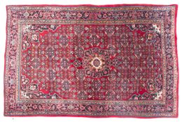 A Bidjar rug, the wine field with a central indigo pole medallion, all over flowerhead,