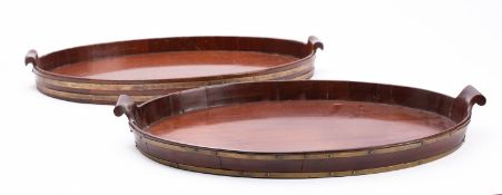 Two similar mahogany and brass bound oval trays in George II style,