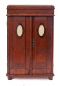 A miniature oak wardrobe in Art Deco style, circa 1930; possibly an apprenticeman's piece,
