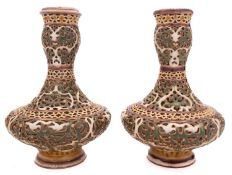 A close pair of Zsolnay Pecs reticulated vases, in the Moorish taste and of squat ogee form,