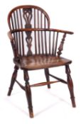 An early 19th Century yew-wood and elm stick back Windsor elbow chair,