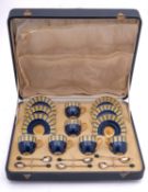 A Royal Worcester porcelain cased coffee service decorated in the Art Deco style with a band of