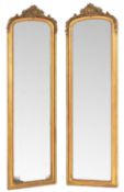 A pair of Victorian gilt composition framed pier mirrors in Rococo revival style,