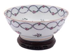 A French porcelain punch bowl in Chinese export style painted with floral garlands and sprays,