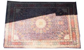 A Kashmiri carpet, the indigo field with a central ivory radiating flowerhead medallion,