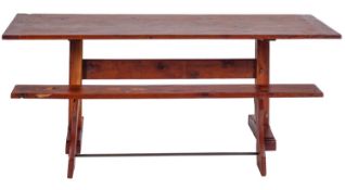A yew wood trestle table,