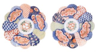 A pair of Japanese Fukugawa porcelain saucer dishes of scalloped form profusely decorated with a