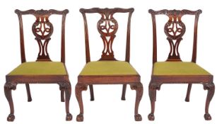A set of seven late George II mahogany dining chairs,