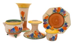 A Clarice Cliff Bizarre cauldron, a flared vase, a candlestick,