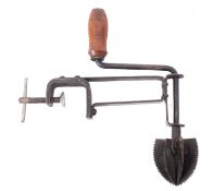 The Odiris bench mounted iron coconut scraper, with turned wood handle.