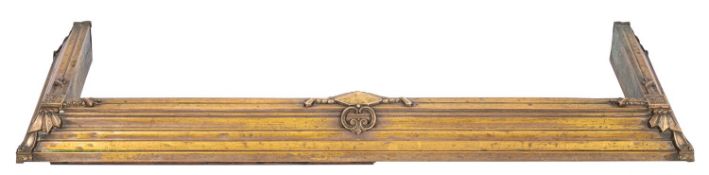 A brass fender in Arts & Crafts style,