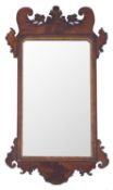 A parcel gilt walnut framed wall mirror in George I taste,