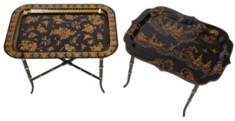 A black lacquered and parcel gilt rectangular tray on stand, in Regency style,