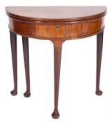 A George II mahogany half round tea table, with a hinged top and box interior,