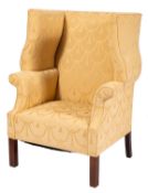 An upholstered wing back armchair in George II style,