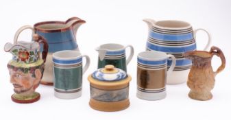 A group of mocha ware, comprising two jugs, two tankards and a tobacco jar and cover,