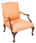 A carved walnut and upholstered Gainsborough armchair in George III style,