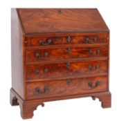A George III mahogany bureau, the sloping hinged fall enclosing a fitted interior,