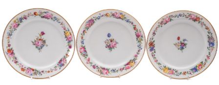 A set of three Paris plates each painted with a central bouquet of flowers within a continuous