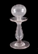 A lace maker's glass lamp, with plain baluster stem and circular base.