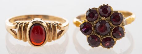 A group of two garnet rings, a 9ct yello