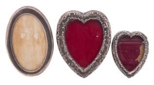 A small silver heart shaped photograph f