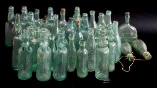 A collection of various glass bottles, various retailers and makers.