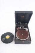 An HMV portable gramophone in black case (worn) together with a small group of 78rpm records