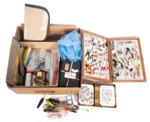 A collection of fly fishing equipment comprising several boxes of steel eye flies, weights,