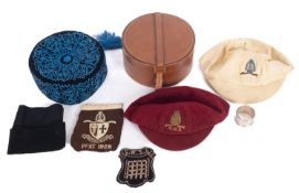 An early 20th century black felt and embroidered smoking hat , in remains of original box,