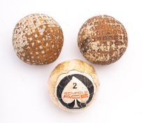 Golfing Interest: two Gutta Percha golf balls, Lynx classic, white, with a Penfold ACE wrapped,