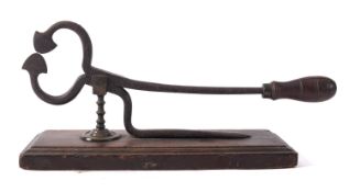 An set of early 19th century iron sugar nips, with turned handle on a wooden plinth base,
