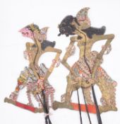 A group of four Javanese Wayang Kulit (shadow puppets) of traditional design together with a Wayang