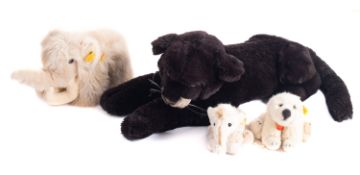 A group of four Steiff animals, including 'Trampy' mammoth, 'Clippy' baby mammoth,