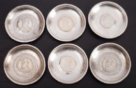 Six dishes, each with Maria Theresa Thaler inset.