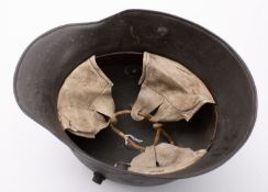 A WWI period German M1916 Stahlhelm, hand painted camouflage finish with white leather liner,