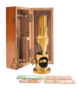 A 19th century lacquered brass filed microscope, with sling tube focus,