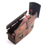 An early 20th century fairground shooting gallery target in the form of a coffin,