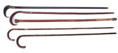 A group of five early 20th century silver mounted walking canes, various makers and dates,