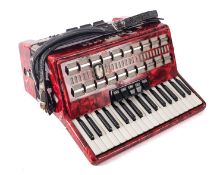 A Bandmaster red marbled piano accordion in case.