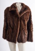 A brown fur jacket by Faulkes, Edgbaston, together with two other brown fur jackets.