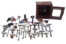 A collection of miscellaneous carriage and door keys, together with a mahogany and glazed key box.