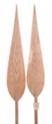 Two South Pacific carved wood ceremonial dancing paddles with elongated leaf shaped blades and