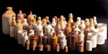 A collection of various stoneware bottles and jars, various retailers and makers.