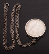 A 1922 Peace Dollar (USA) in mount with chain.