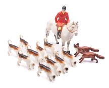 A Beswick Hunting group, comprising Huntsman Standing , grey colourway, ten hounds and two foxes,